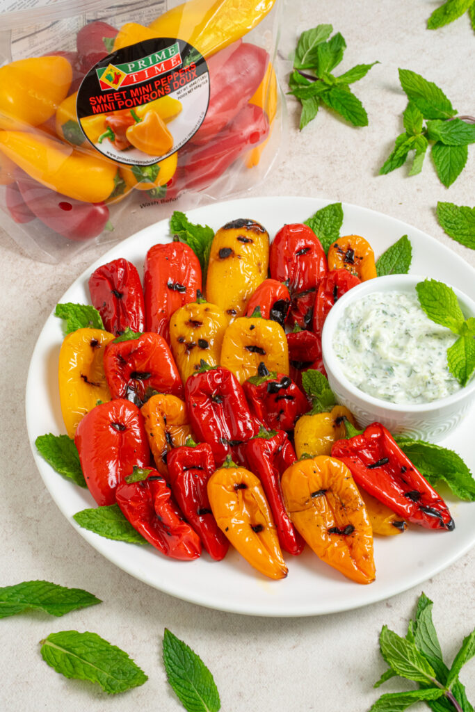 Grilled mini peppers on a plate.