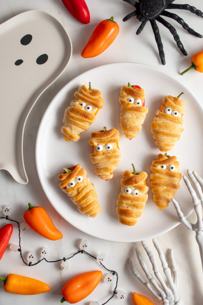 Mini pepper mummies on a white plate.